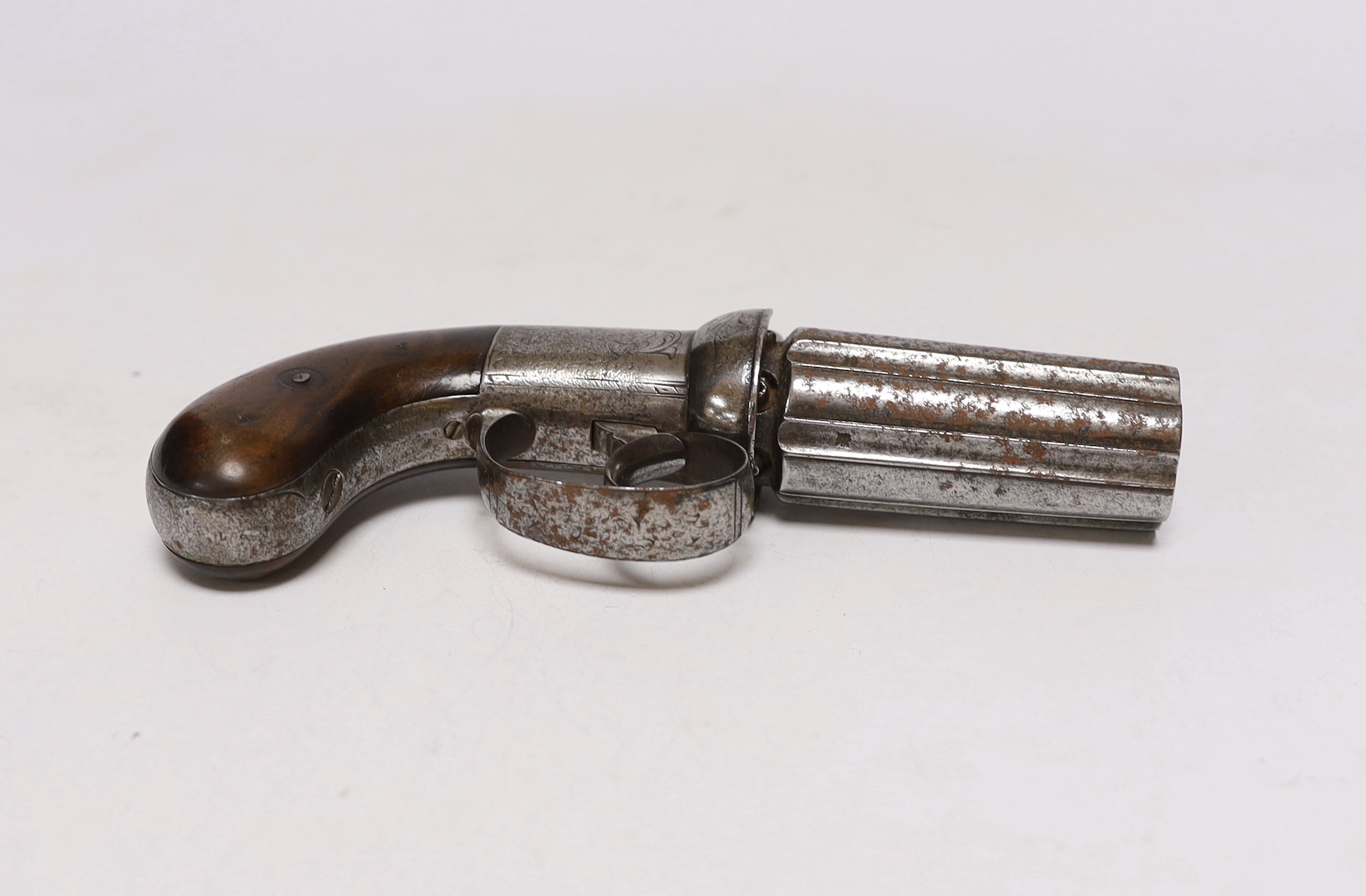 A mid-19th century six shot self-cocking percussion pepper box revolver, with foliate engraved frame, fluted barrels and two piece walnut grips, barrel 7.5cm